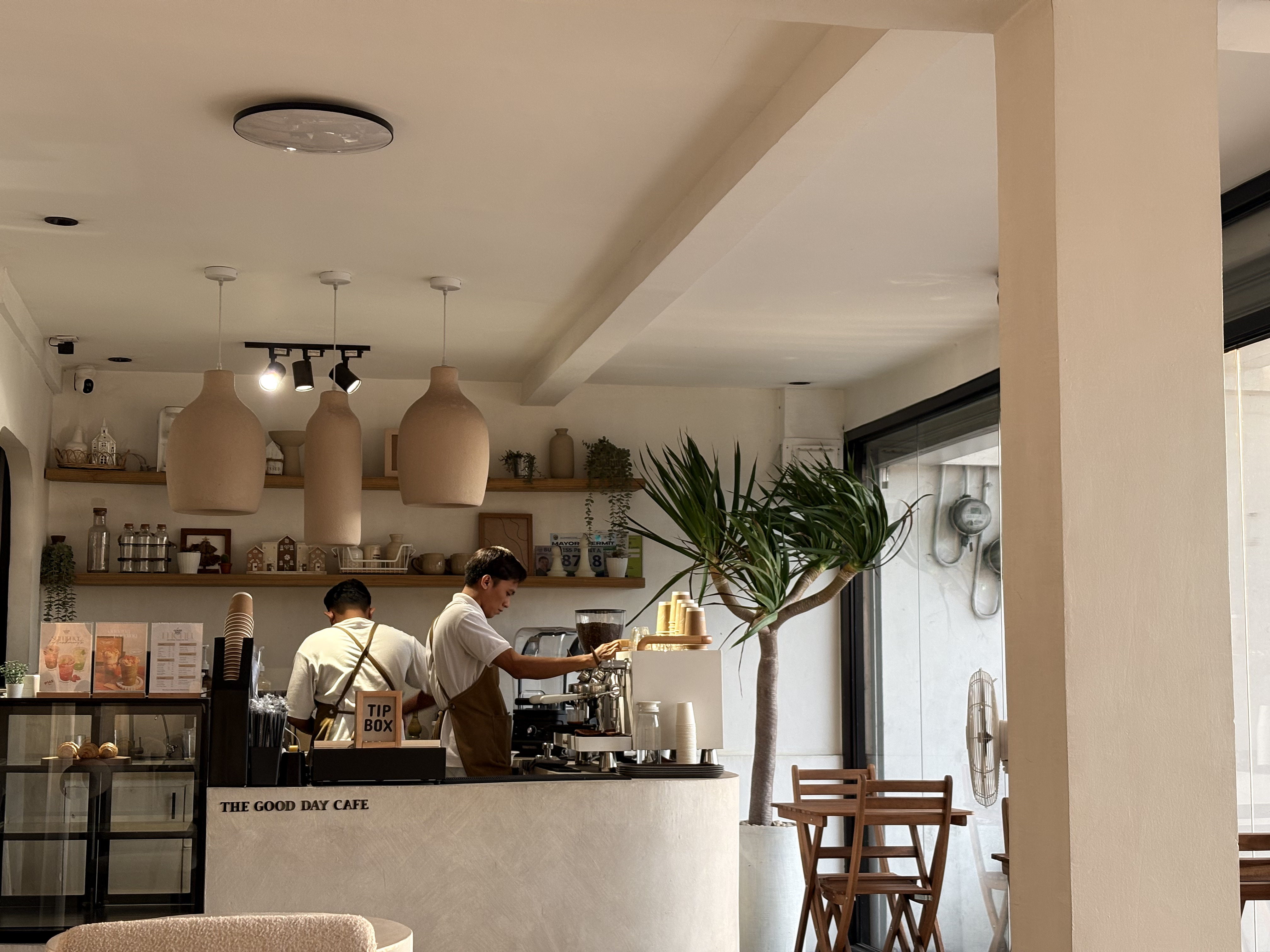 Cozy cafe interior with warm wooden furnishings and ambient lighting.